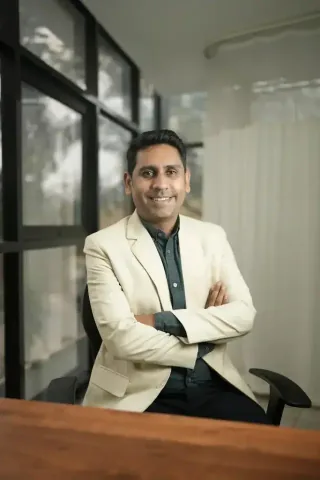 Professional portrait of Dr Kundan Kharde wearing a cream blazer, Pune